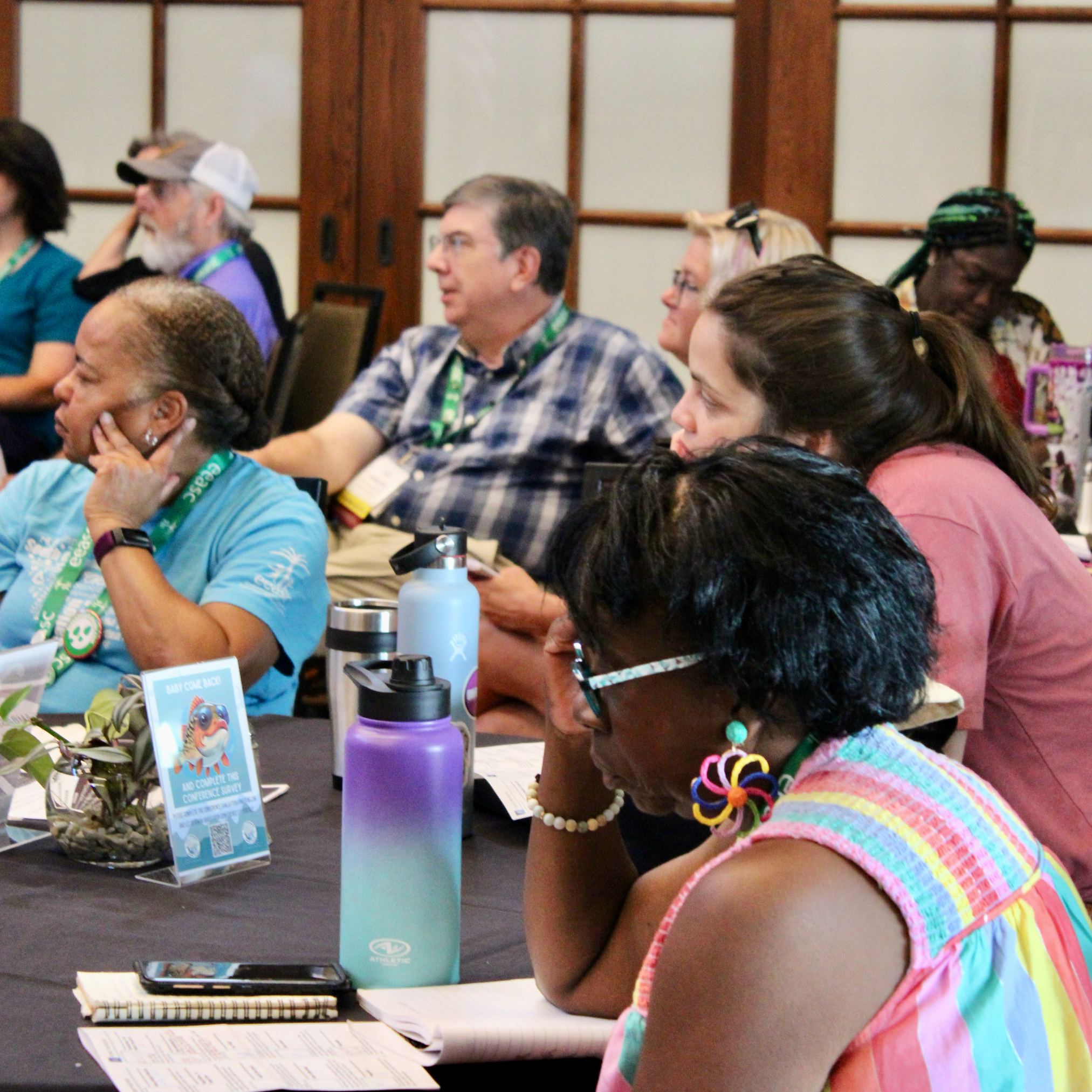 Group of environmental educators listen to presenter at conference